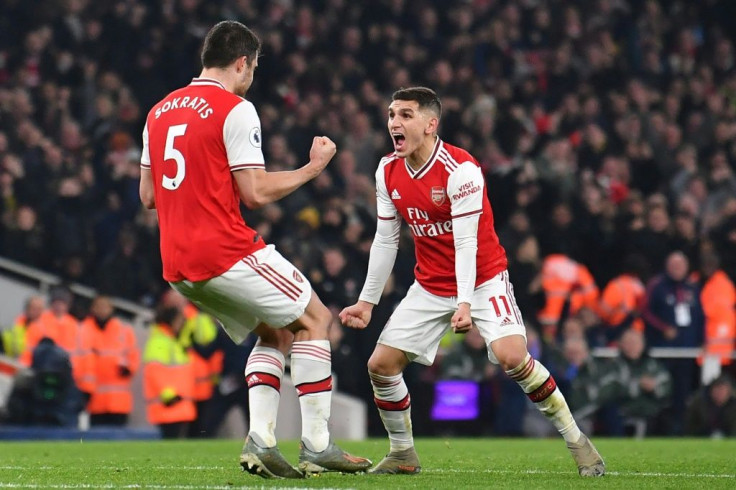 Sokratis Papastathopoulos (left) celebrates Arsenal's second goal against Manchester United