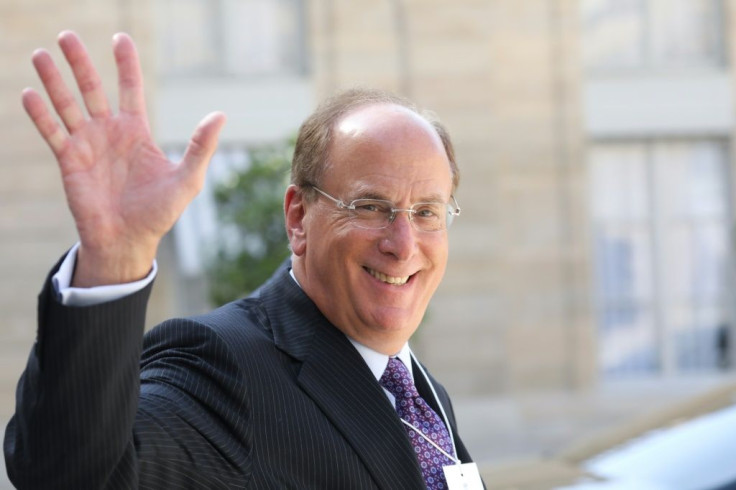 CEO Larry Fink waves as he leaves a meeting about climate action investmentsat the Elysee Palace in Paris in July 2019