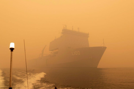 The Royal Australian Navy ship HMAS Choules sails amid heavy smoke off the coast of Mallacoota, Victoria state to assist in bushfire relief efforts