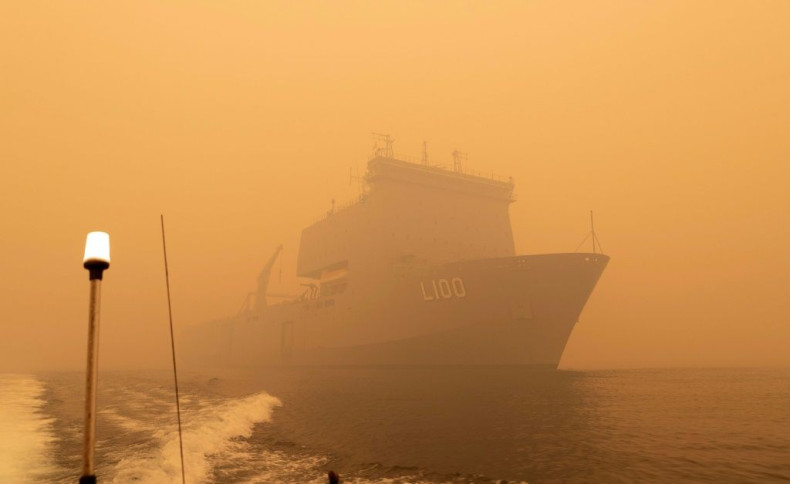 The Royal Australian Navy ship HMAS Choules sails amid heavy smoke off the coast of Mallacoota, Victoria state to assist in bushfire relief efforts