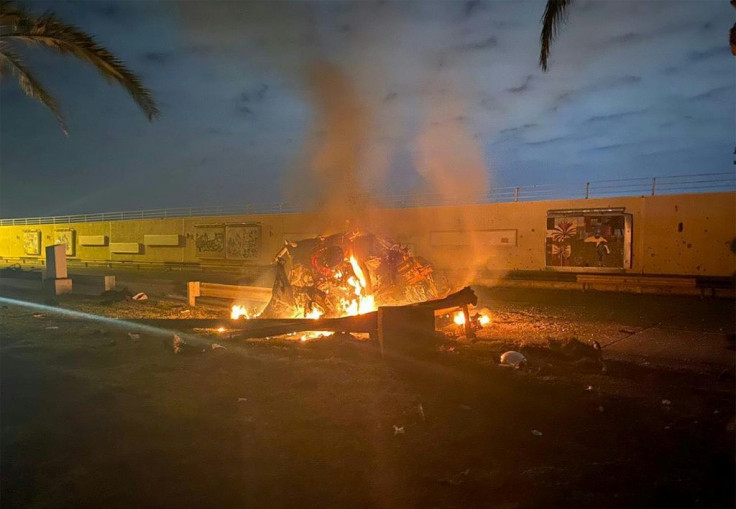 A picture published by the media office of the Iraqi military's joint operations forces shows a destroyed vehicle on fire following a US strike on Baghdad international airport road in which top Iranian commander Qasem Soleimani was killed