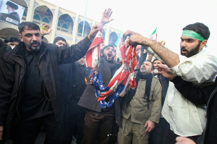 Iranians burn a US flag during a demonstration against American "crimes" in Tehran  following the killing of Iranian Revolutionary Guards Major General Qasem Soleimani in a US strike on his convoy at Baghdad international airport