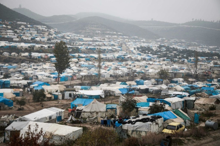 This picture taken on December 12, 2019 shows  a camp for displaced Syrians at Khirbet al-Joz in Syria's Idlib province near Turkey; most of its residents survive on aid brought across the border