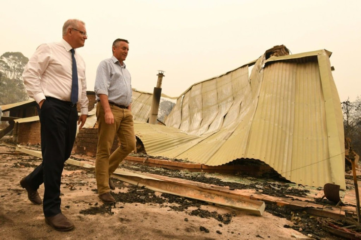 Australia's Prime Minister Scott Morrison (L) has faced sustained anger for his handling of the months-long bushfire crisis