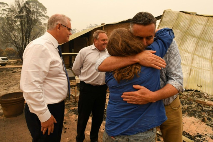 Australia's Prime Minister Scott Morrison (L) has vowed every resource will be provided to help ease the bushfire disaster