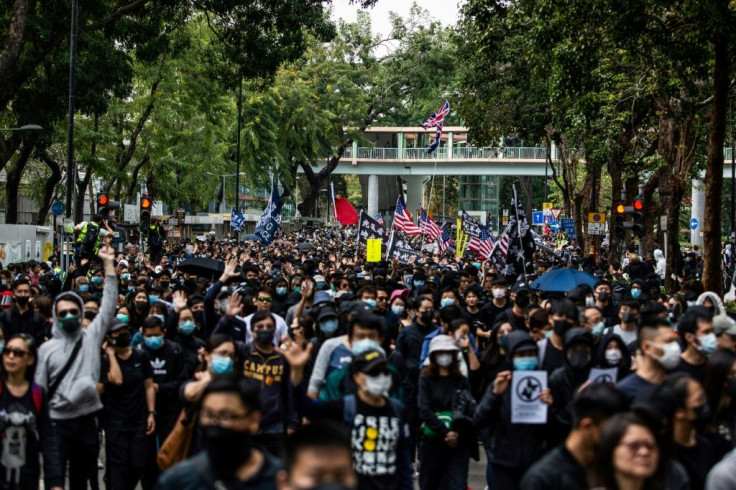 Hong Kong protesters march along a street during a demonstration against parallel trading in Sheung Shui, near the China border