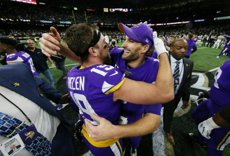 Minnesota Vikings quarterback Kirk Cousins, right, celebrates with Adam Thielen, left, after the Vikings defeated the New Orleans Saints 26-20 in the NFL playoffs Sunday