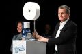 Procter & Gamble's chief brand officer displays a smartphone-activated robot that delivers toilet paper to the bathroom when summoned