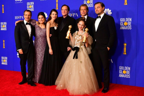 US film director Quentin Tarantino (C), poses with cast and crew of "Once Upon A Time... In Hollywood" including actors Brad Pitt (next to Tarantino) and Leonardo DiCaprio, after the film won three Golden Globes