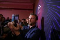 A man uses a new TCL 10 series phone at the TCL news event during the 2020 Consumer Electronics Show (CES) in Las Vegas