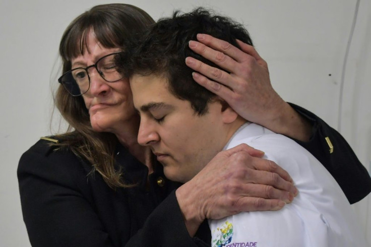 Denise Vicentin (L) embraces her doctor, Rodrigo Salazar, after receiving a digitally-engineered facial prosthesis