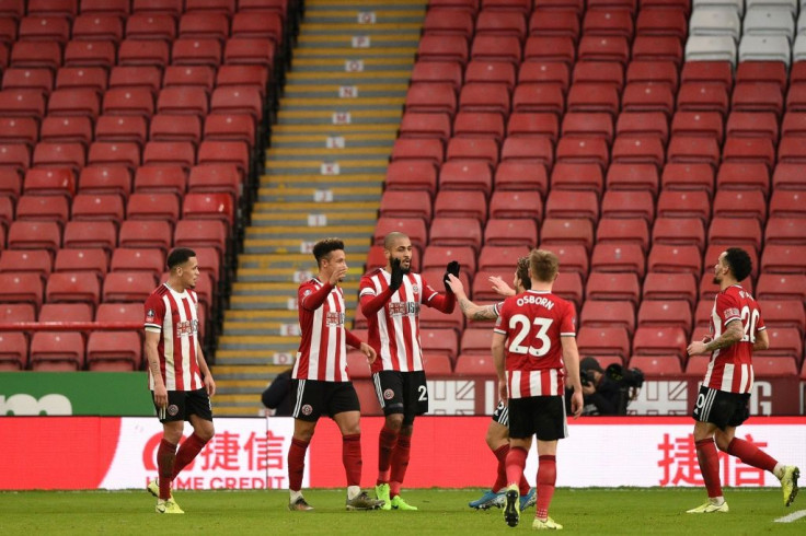 Sheffield United celebrate their second goal in front of empty seats during their FA Cup third round match against Fylde