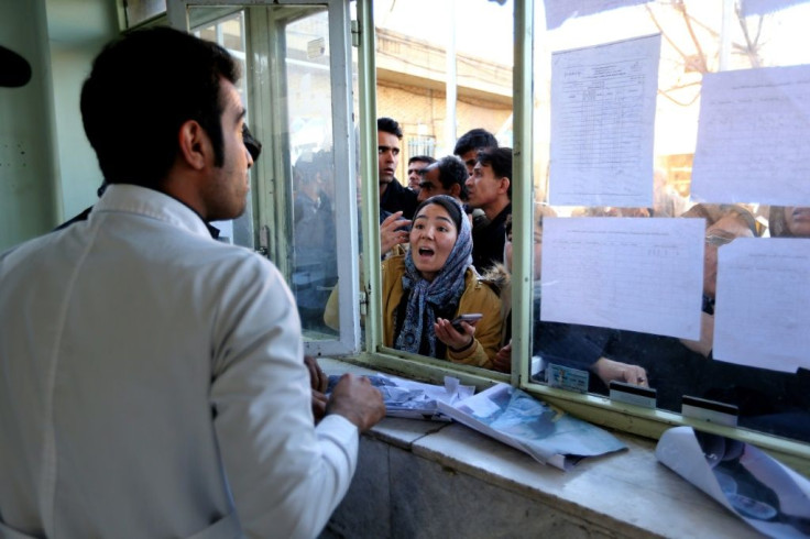 Iranians search for their relatives at a hospital following the stampede