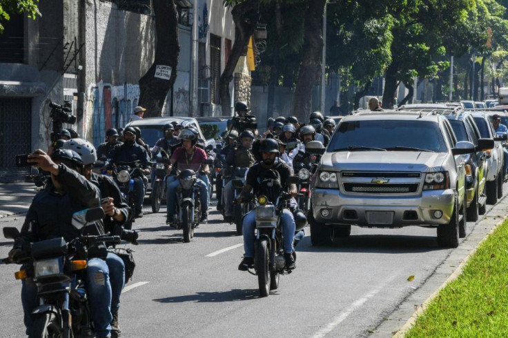 A caravan carrying Venezuelan opposition leader and self-proclaimed acting president Juan Guaido to the National Assembly, followed by journalists on motorcycles