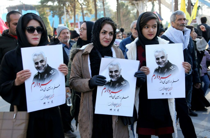Iranian mourners hold posters of slain top general Qasem Soleimani during the final stage of funeral processions in his hometown Kerman