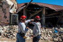 Two firemen survey a collapsed building after an earthquake hit Guanica, one of the towns which appeared to suffer the worst damage on Puerto Rico's southwest coast