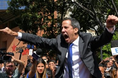 Venezuelan opposition leader and self-proclaimed acting president Juan Guaido shouts on his way to the National Assembly, in Caracas, on January 7, 2020, where he claimed the speaker's chair