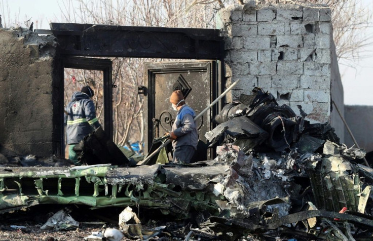 Rescue teams work amidst debris after a Ukrainian plane carrying 176 passengers crashed near Imam Khomeini airport in the Iranian capital Tehran early in the morning on January 8, 2020, killing everyone on board