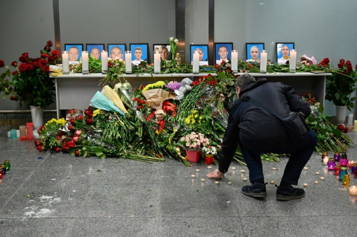 Dozens of people -- airline staff, passengers and locals alike -- gathered in the departure area to pay their respects to the crew, five men and four women