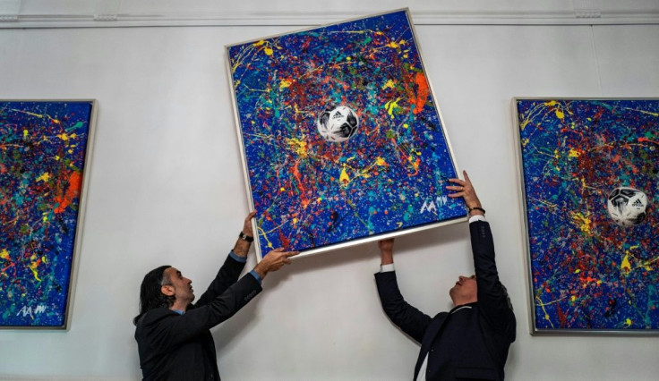 His father and manager Kerem Akar (L) says they discovered Mikail's talent by chance after giving him paints and a canvas as a fourth birthday present