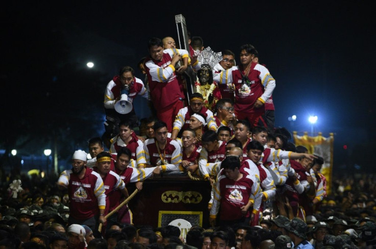 The protectors serve as human armour during the procession through Manila of the historic statue of Jesus Christ