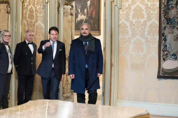 Italy's Prime Minister Giuseppe Conte (3rdL) welcomes Libya's military strongman Khalifa Haftar (R) for talks in Rome