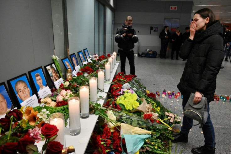 A woman in front of a memorial at the Boryspil airport outside Kiev  for the victims of the Ukraine International Airlines Flight PS752, which crashed shortly after takeoff in Tehran Wednesday killing all 176 aboard