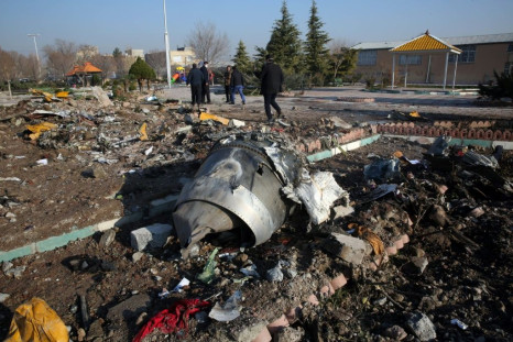 Rescue teams work among debris after a Ukrainian plane carrying 176 passengers crashed near Imam Khomeini airport in the Iranian capital Tehran