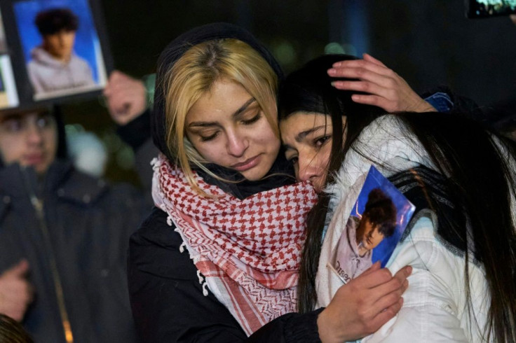 Mourners in Toronto console each other during a vigil for the victims of Ukrainian Airlines flight 752 which went down in Iran, killing everybody aboard