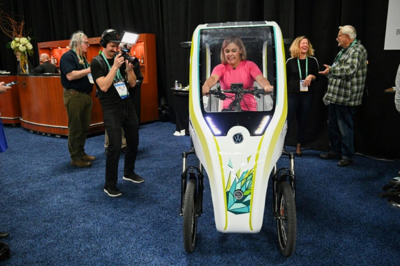 An attendee sits in the Wello solar electric tricycle during the CES Unveiled preview at the 2020 Consumer Electronics Show