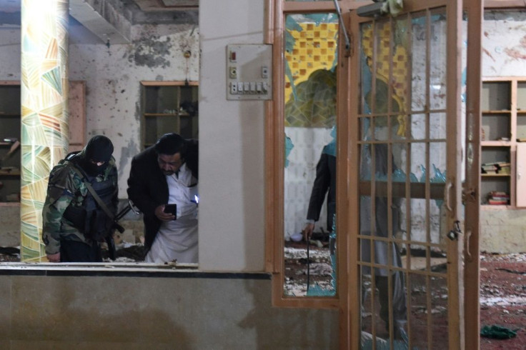 Security officials examine a mosque on the outskirts of Quetta after a suicide bomb attack