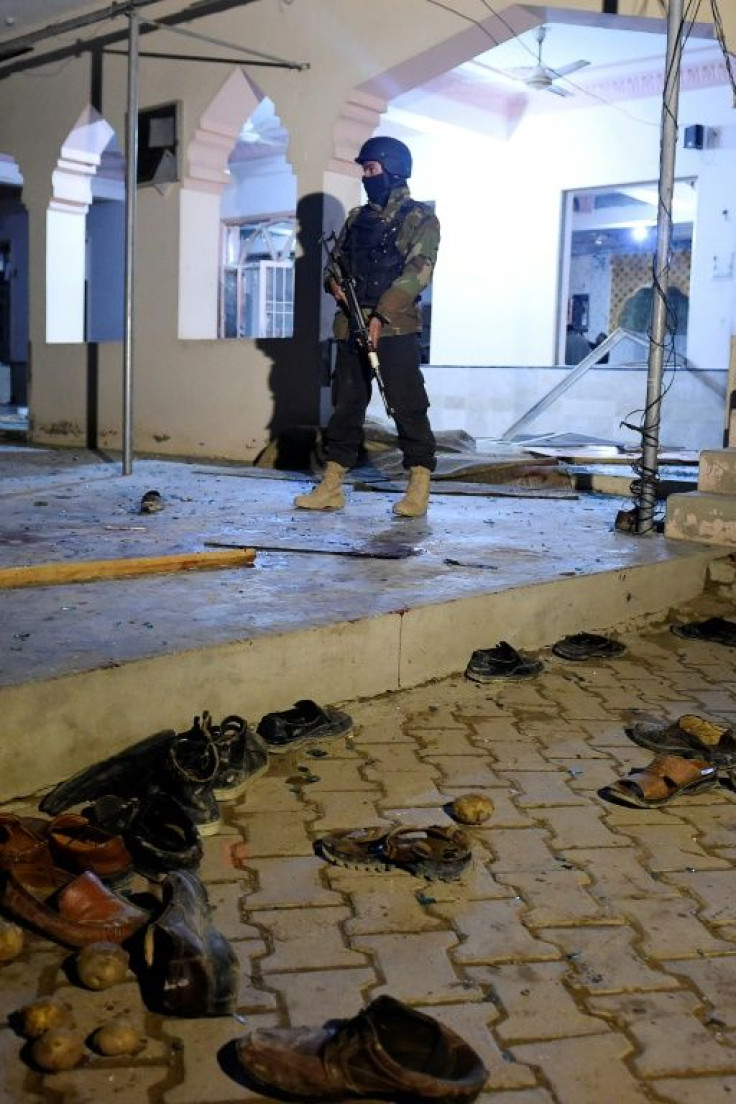 A Pakistani soldier stands guard after a suicide bomb blast at a mosque in the Quetta area