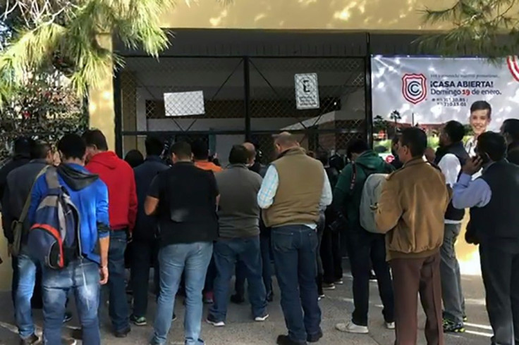 A video grab from AFP TV shows relatives of schoolchildren outside of the elementary school where a student shot and killed a teacher and wounded five other pupils, and then apparently killed himself in Torreon, Mexico on January 10, 2020