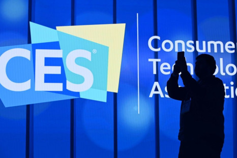 An attendee photographs a sign next to the CES logo ahead of the first keynote address at the 2020 Consumer Electronics Show  in Las Vegas, Nevada