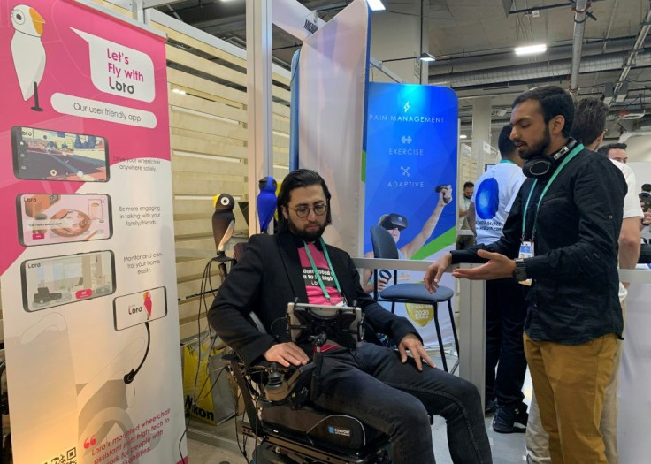 David Hojah (L), cofounder and CEO of Loro, shows the robot assistant for the wheelchair-bound at the 2020 Consumer Electronics Show
