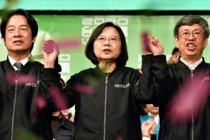 Taiwan President Tsai Ing-wen (C) joins hands with Vice President-elect William Lai (L) and current Vice President Chen Chien-jen at campaign headquarters in Taipei on January 11, 2020; she was re-elected in a lopsided vote seen as a blow to China