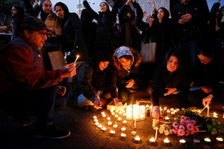 Iranians light candles for the victims of Ukraine International Airlines Boeing 737 during a gathering in front of the Amirkabir University in the capital Tehran on Saturday