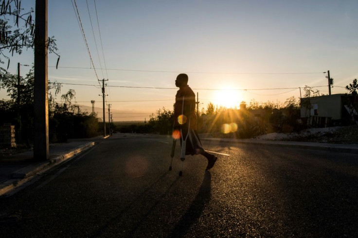 This photo shows Boulva Verly, 42, walking with crutches on the streets of Croix des Bouquets; he lost a leg in the 2010 quake, making him one of 300,000 Haitians to be injured