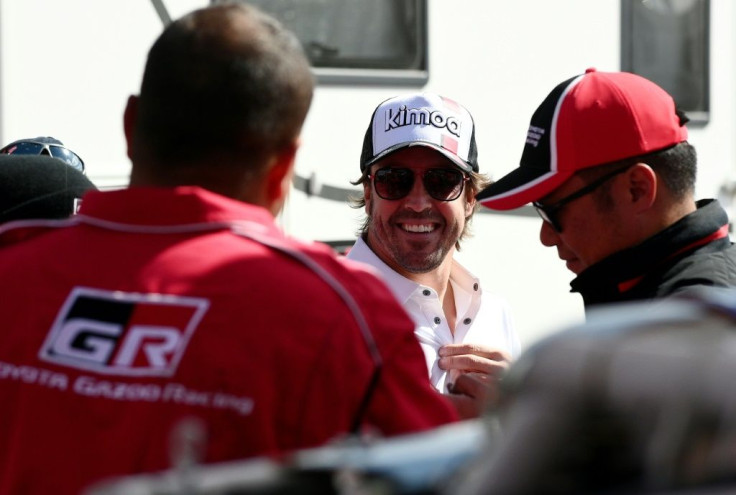 Day off: Fernando Alonso jokes with Toyota mechanics on Saturday