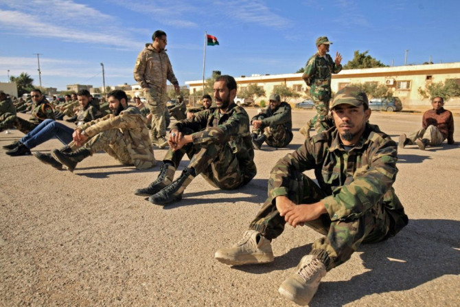 Fighters of a battalion loyal to Libyan General Khalifa Haftar pictured in the eastern city of Benghazi in December 2019. Both sides in Libya's conflict agreed to a ceasefire that started early Sunday