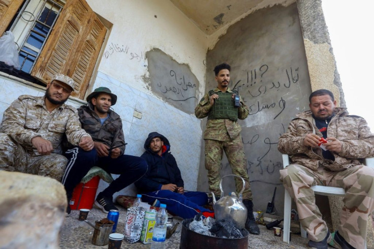 Fighters loyal to Libya's Government of National Accord take advantage of a ceasefire to rest in an area south of the capital Tripoli