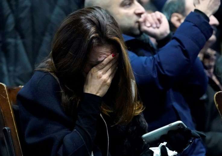 A woman weeps during a memorial service at the University of Toronto in Toronto, Ontario on January 12 for the victims of Ukrainian Airlines flight 752 which was shot down over Iran