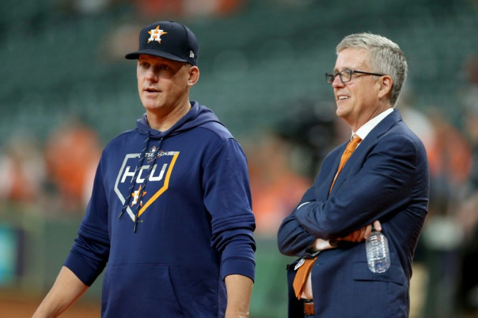 Banned: Astros skipper A.J. Hinch (left) and general manager Jeff Luhnow have been banned for the entirety of the 2020 season over allegations of cheating in 2017
