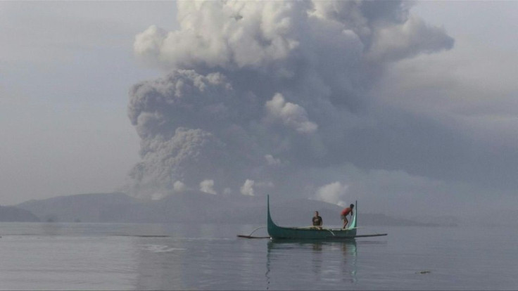 Broad columns of ash spewed from a volcano south of the Philippine capital on Monday, grounding hundreds of flights and causing residents to use face masks.