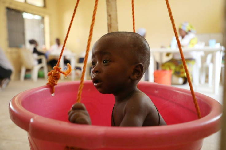 A sick child is weighed on makeshift scales at a Doctors Without Borders (MSF) clinic in Anka