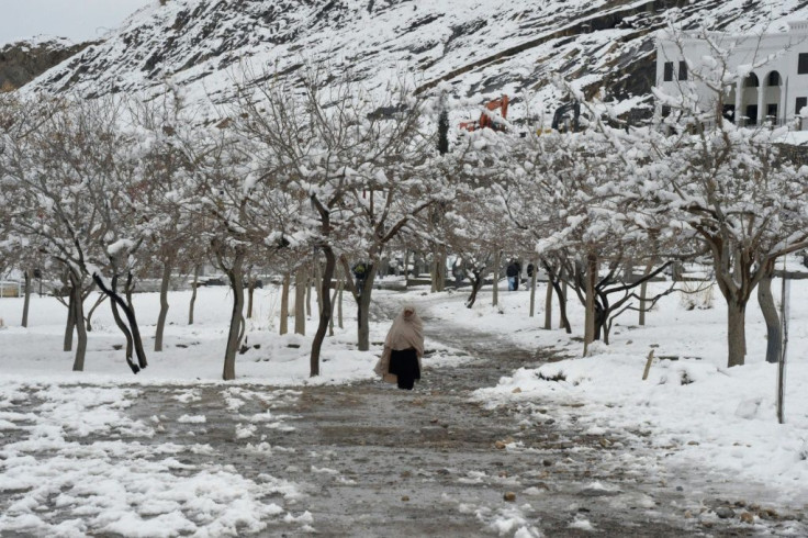 A woman walks down a path in Quetta, Pakistan, after heavy snow