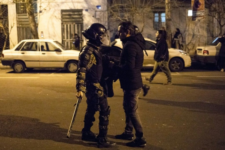 An Iranian man confronts a policeman during a demonstration outside Tehran's Amir Kabir University in January 2020