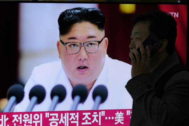 The US alleges that the regime of North Korean leader Kim Jong Un -- seen here on a television screen in December 2019 -- reaps the salary benefits of its overseas workers