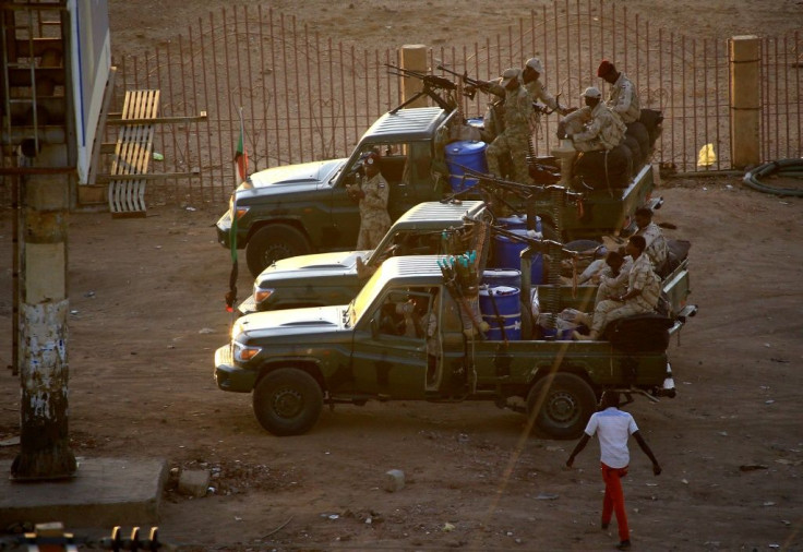 Members of Sudan's intelligence services shoot bullets in the air at the headquarters of the Directorate of General Intelligence Service in the Riyadh district of the capital Khartoum