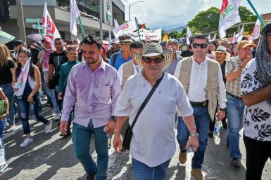 Rodrigo Londono aka Timochenko (C), seen here taking part in a general strike against the government Colombian President Ivan Duque in Medellin in November
